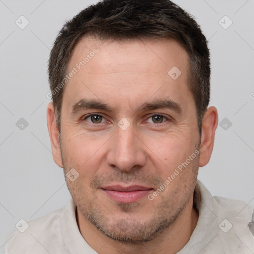 Joyful white adult male with short  brown hair and brown eyes