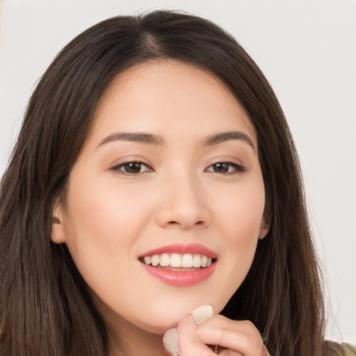 Joyful white young-adult female with long  brown hair and brown eyes