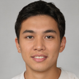 Joyful asian young-adult male with short  brown hair and brown eyes