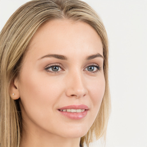 Joyful white young-adult female with long  brown hair and green eyes