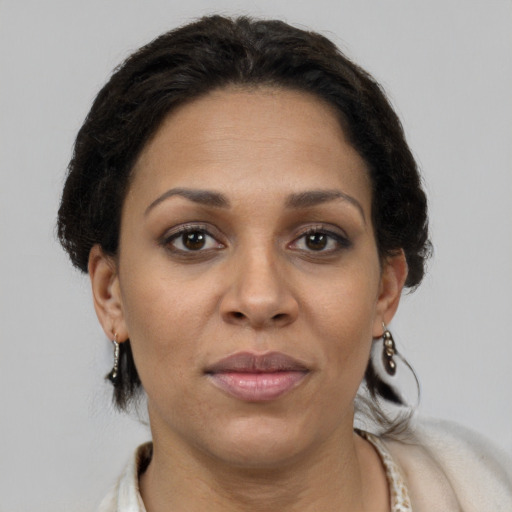 Joyful latino adult female with short  brown hair and brown eyes