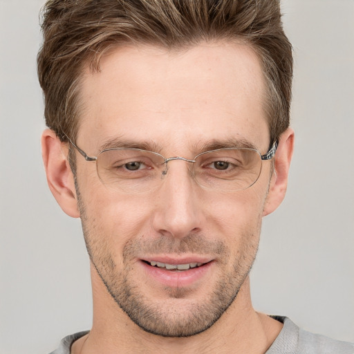 Joyful white adult male with short  brown hair and grey eyes