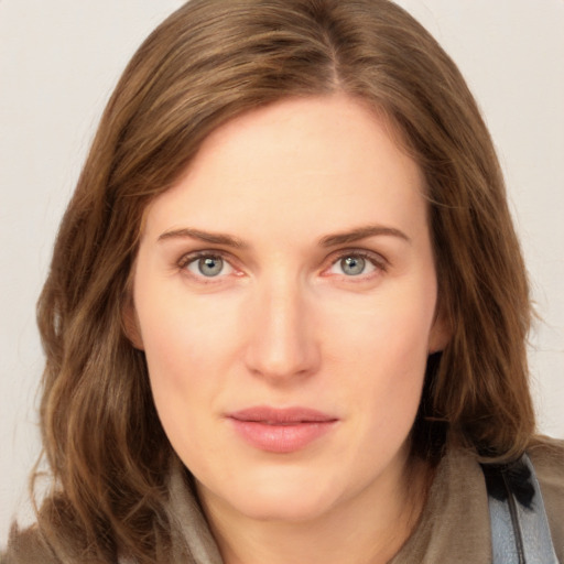 Joyful white young-adult female with long  brown hair and blue eyes