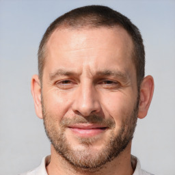 Joyful white adult male with short  brown hair and brown eyes