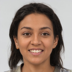 Joyful latino young-adult female with medium  brown hair and brown eyes