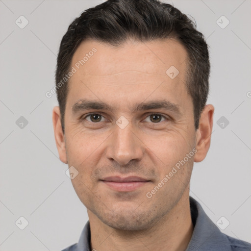 Joyful white adult male with short  black hair and brown eyes