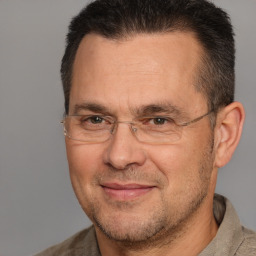 Joyful white adult male with short  brown hair and brown eyes