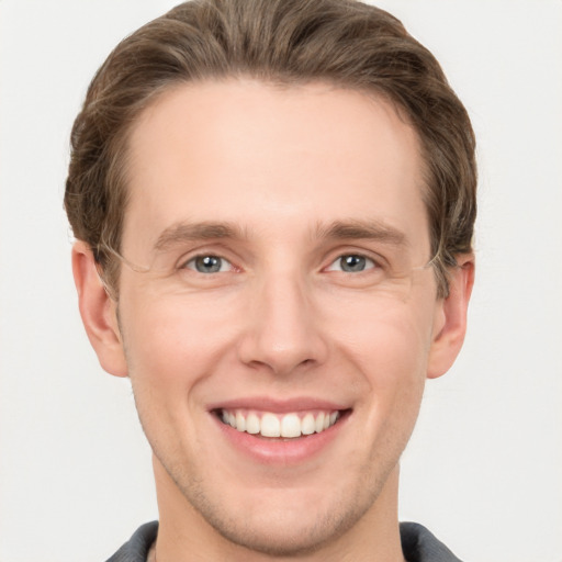 Joyful white adult male with short  brown hair and grey eyes