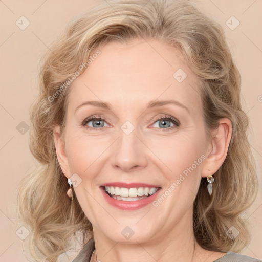 Joyful white young-adult female with medium  brown hair and blue eyes