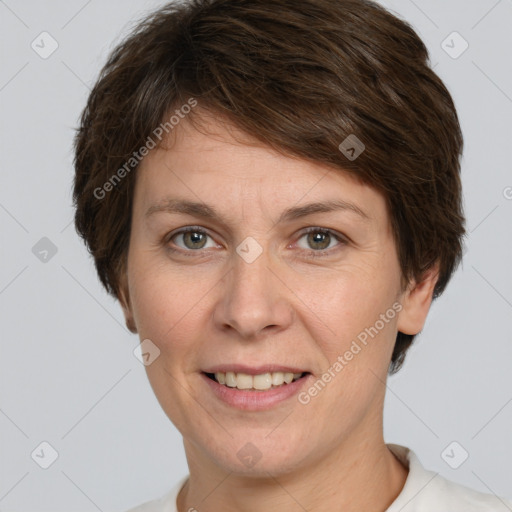 Joyful white young-adult female with short  brown hair and grey eyes