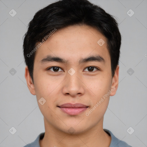 Joyful asian young-adult male with short  brown hair and brown eyes