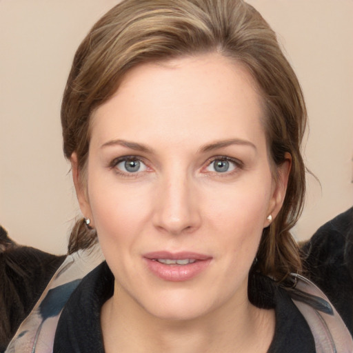 Joyful white young-adult female with medium  brown hair and grey eyes