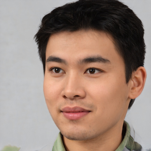 Joyful white young-adult male with short  black hair and brown eyes