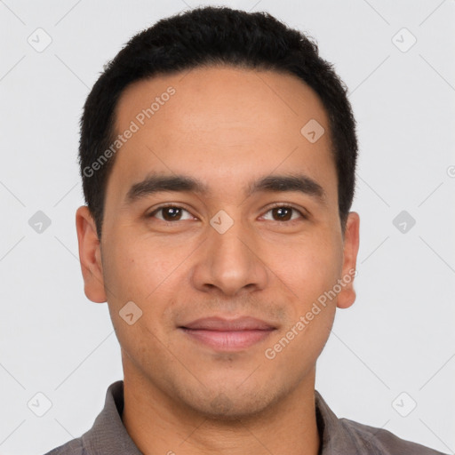 Joyful latino young-adult male with short  brown hair and brown eyes