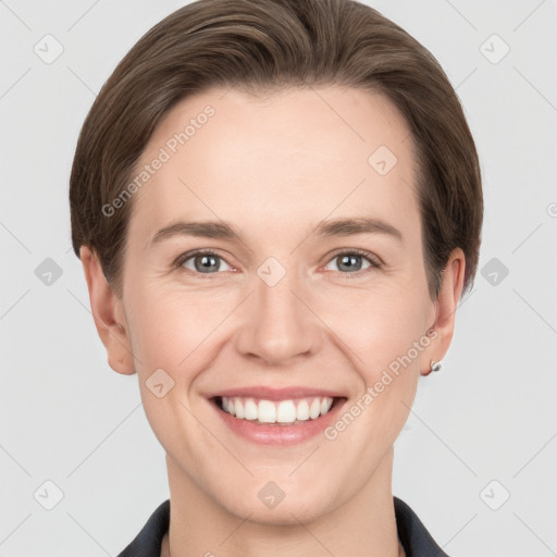 Joyful white young-adult female with short  brown hair and grey eyes