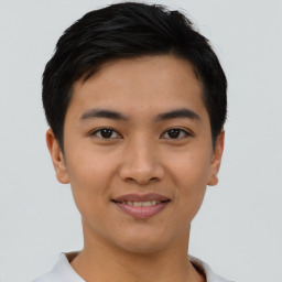 Joyful asian young-adult male with short  black hair and brown eyes