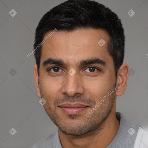 Joyful latino young-adult male with short  black hair and brown eyes