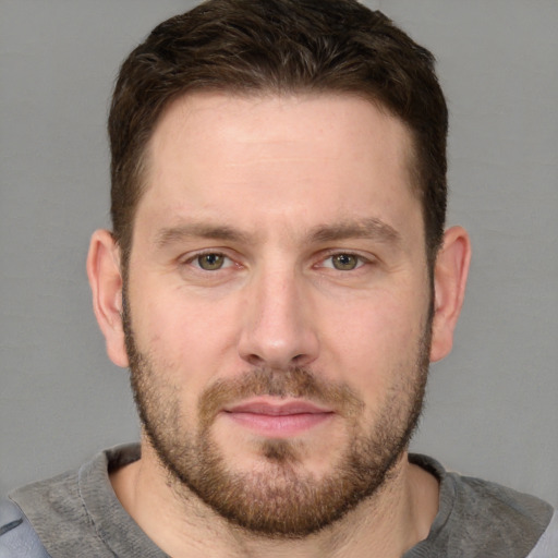 Joyful white adult male with short  brown hair and grey eyes