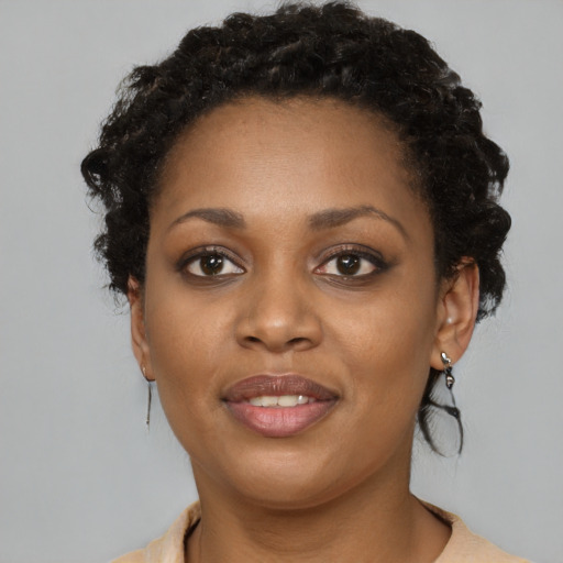 Joyful black young-adult female with medium  brown hair and brown eyes