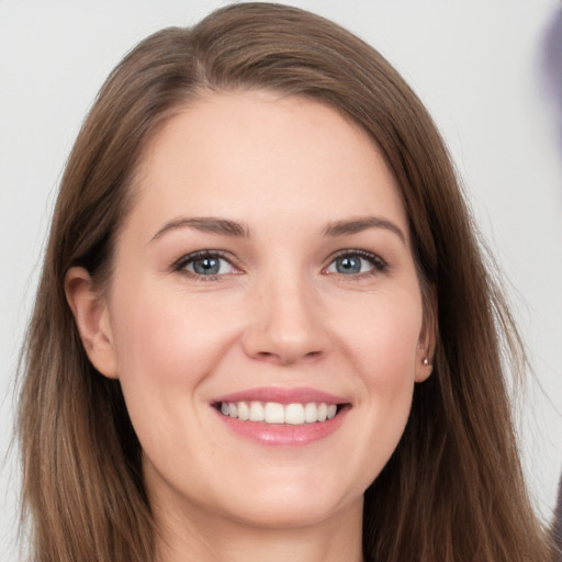 Joyful white young-adult female with long  brown hair and grey eyes