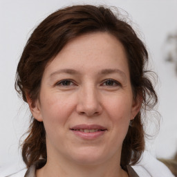 Joyful white adult female with medium  brown hair and grey eyes