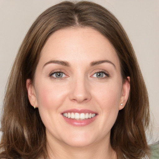 Joyful white young-adult female with medium  brown hair and grey eyes