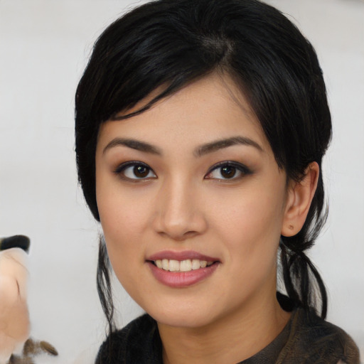 Joyful asian young-adult female with medium  black hair and brown eyes