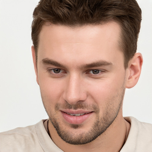 Joyful white young-adult male with short  brown hair and grey eyes