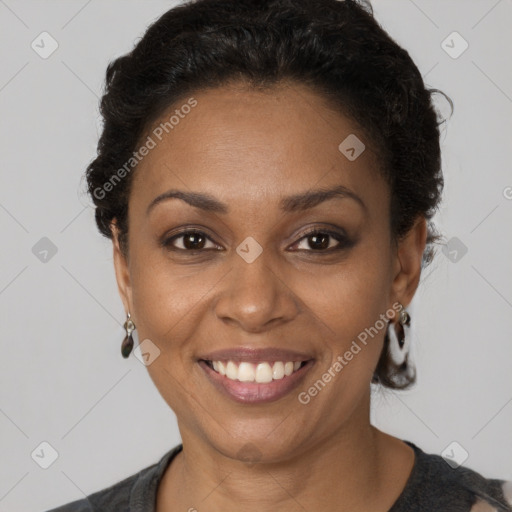 Joyful black adult female with short  brown hair and brown eyes