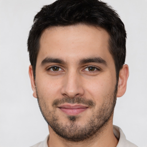 Joyful white young-adult male with short  black hair and brown eyes