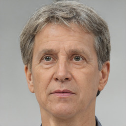 Neutral white middle-aged male with short  gray hair and brown eyes