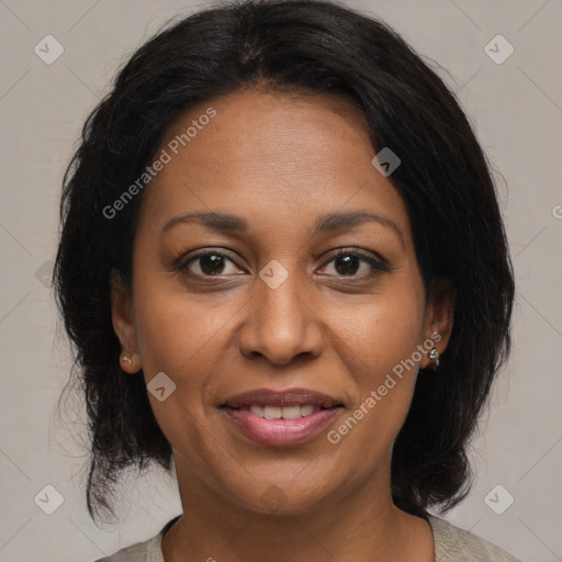 Joyful black adult female with medium  brown hair and brown eyes