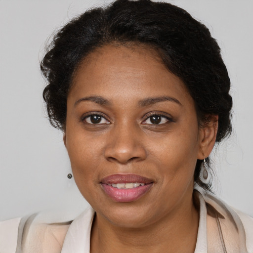 Joyful black adult female with medium  brown hair and brown eyes