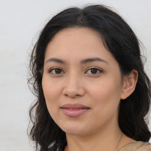 Joyful latino young-adult female with medium  brown hair and brown eyes