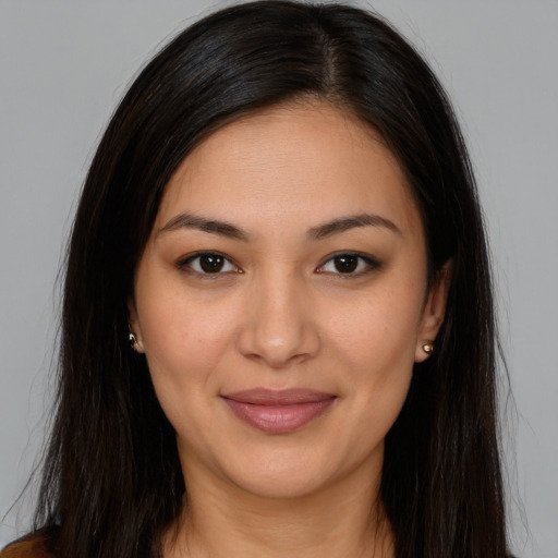 Joyful latino young-adult female with long  brown hair and brown eyes