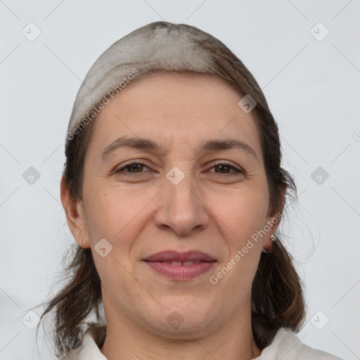 Joyful white adult female with medium  brown hair and brown eyes