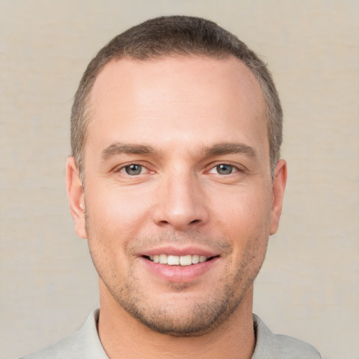 Joyful white young-adult male with short  brown hair and brown eyes