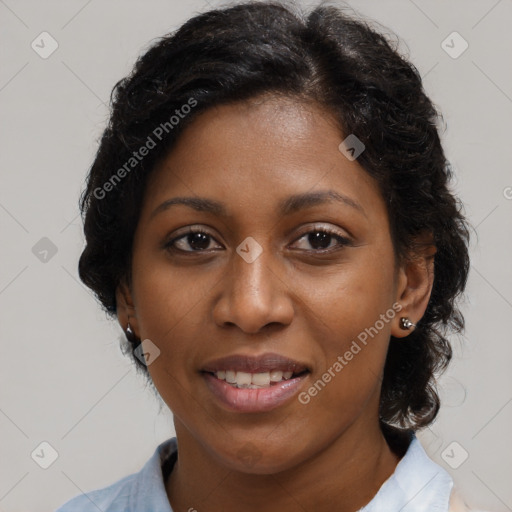 Joyful black adult female with medium  brown hair and brown eyes