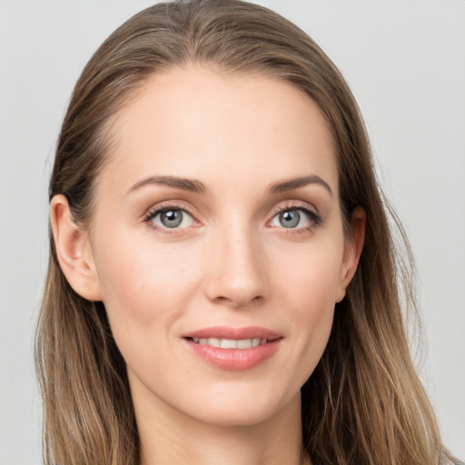 Joyful white young-adult female with long  brown hair and blue eyes