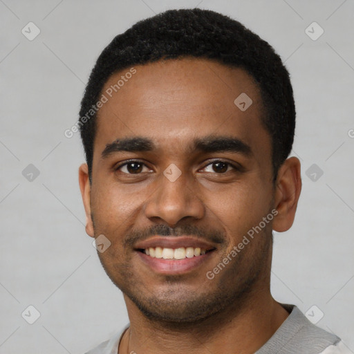 Joyful black young-adult male with short  black hair and brown eyes