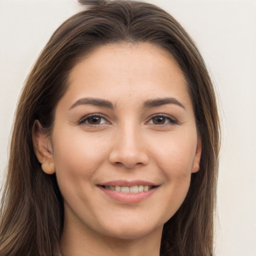 Joyful white young-adult female with long  brown hair and brown eyes