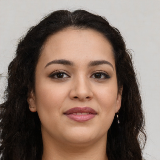 Joyful latino young-adult female with long  brown hair and brown eyes