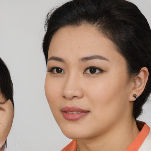 Neutral asian young-adult female with medium  brown hair and brown eyes