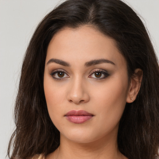 Joyful white young-adult female with long  brown hair and brown eyes