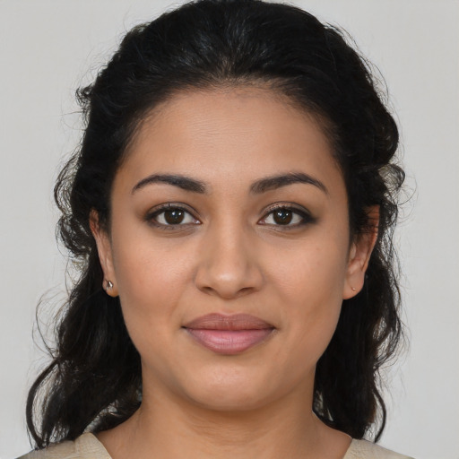 Joyful latino young-adult female with medium  brown hair and brown eyes