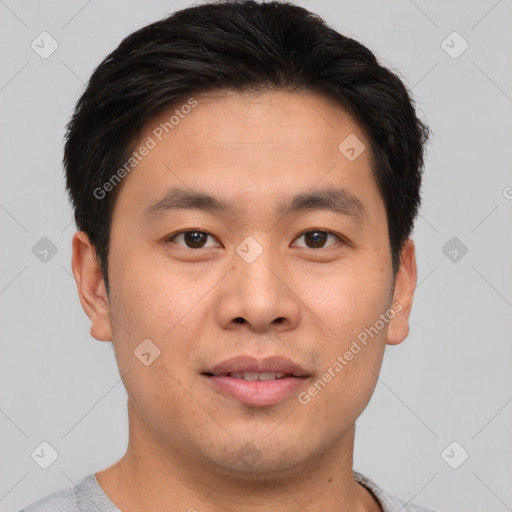 Joyful asian young-adult male with short  brown hair and brown eyes