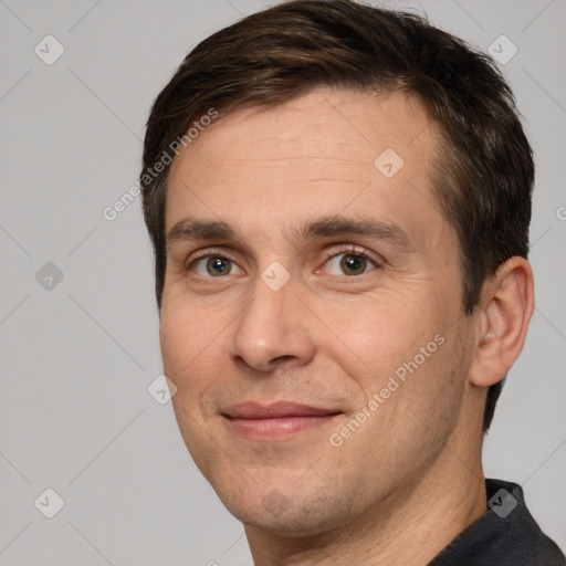 Joyful white adult male with short  brown hair and brown eyes