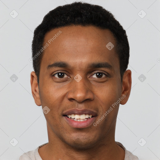 Joyful black young-adult male with short  black hair and brown eyes