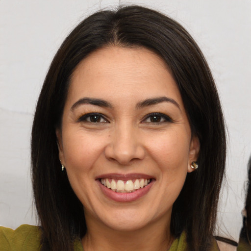 Joyful white young-adult female with long  brown hair and brown eyes