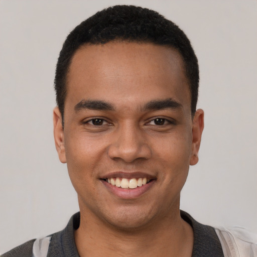 Joyful white young-adult male with short  black hair and brown eyes